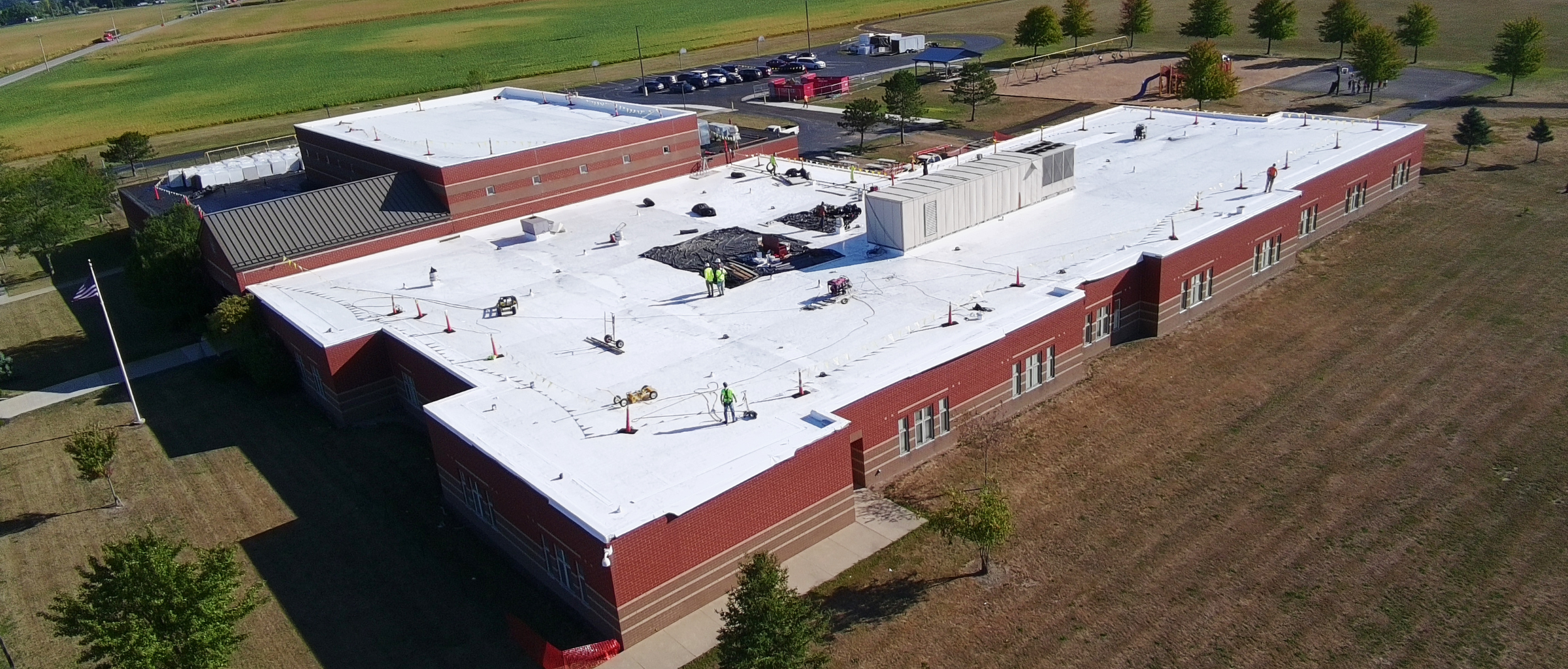 Construction workers working on top of building