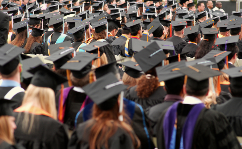 Large group of people wearing graduation caps and gowns